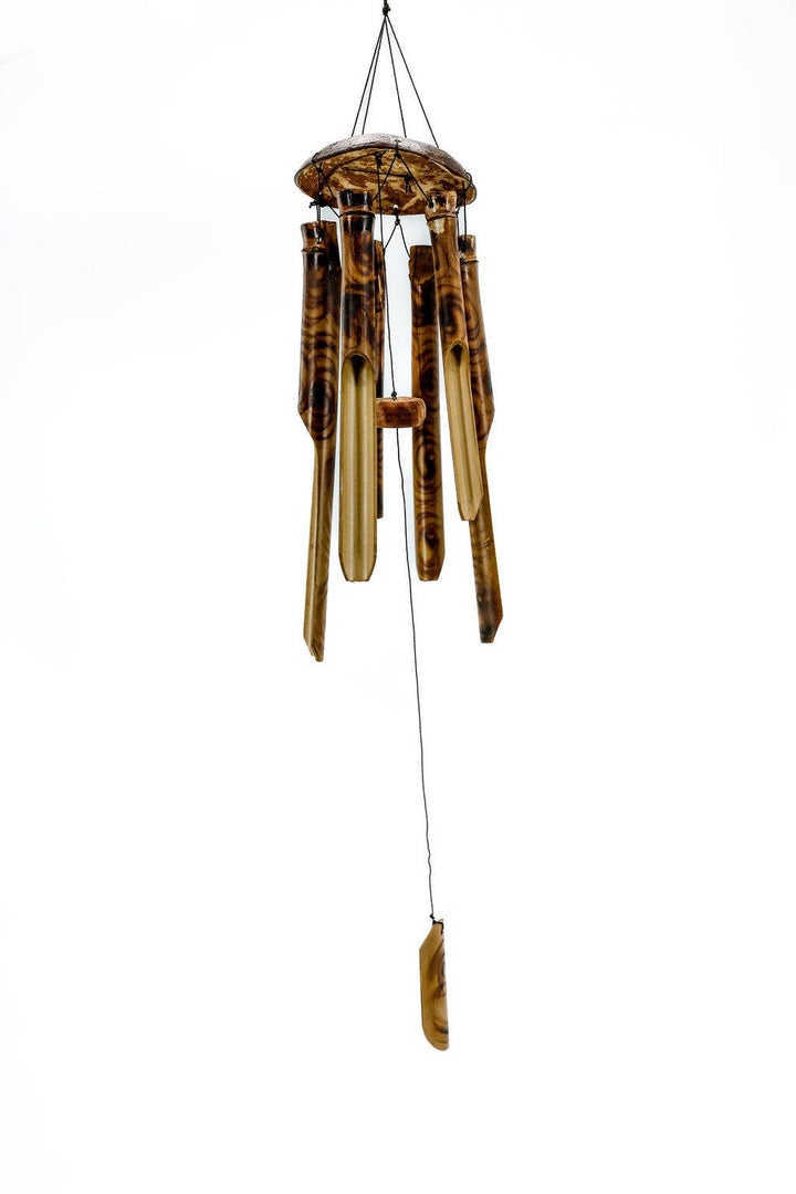 Eco-friendly handmade bamboo wind chime producing soothing sounds on a porch, that's also fair trade crafted.