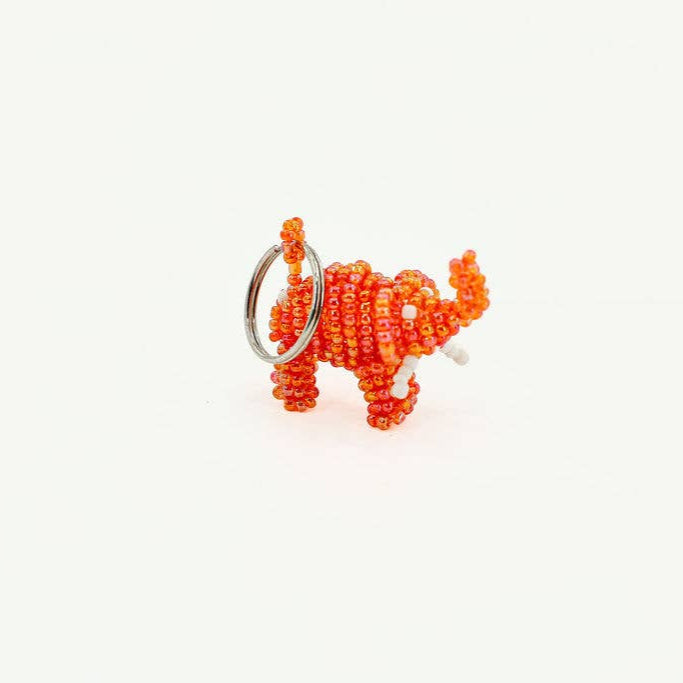 Handmade elephant beaded keychain in bright orange, ethically sourced from Africa.