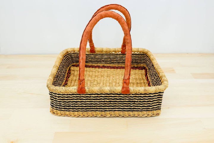 Unique handwoven fair trade basket with leather handles, perfect for farmers market, knitting, or storage.