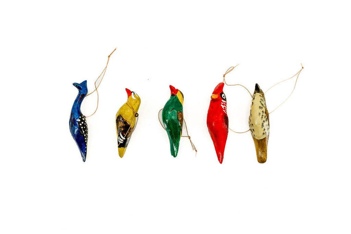 Hand-carved fair trade wooden bird ornament, hand-painted with intricate details for eco-friendly holiday décor.
