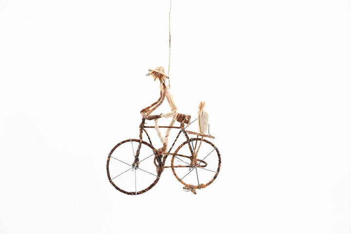 Eco-friendly banana leaf bicycle sculpture with metal wire base, fair trade decor for shelf or wall.