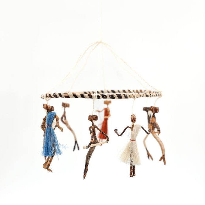 Handmade hanging mobile with colorful dancing figures.