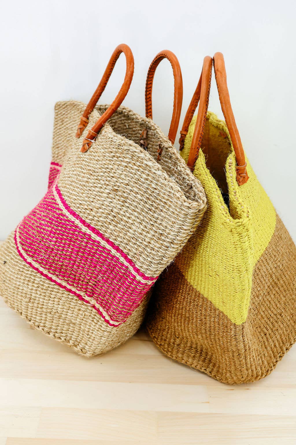 Handwoven sisal tote bag with leather handles from Kenya.