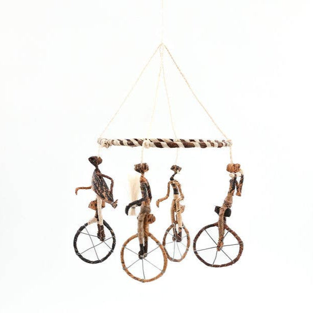 Handmade fair trade mobile with unicycle acrobats.