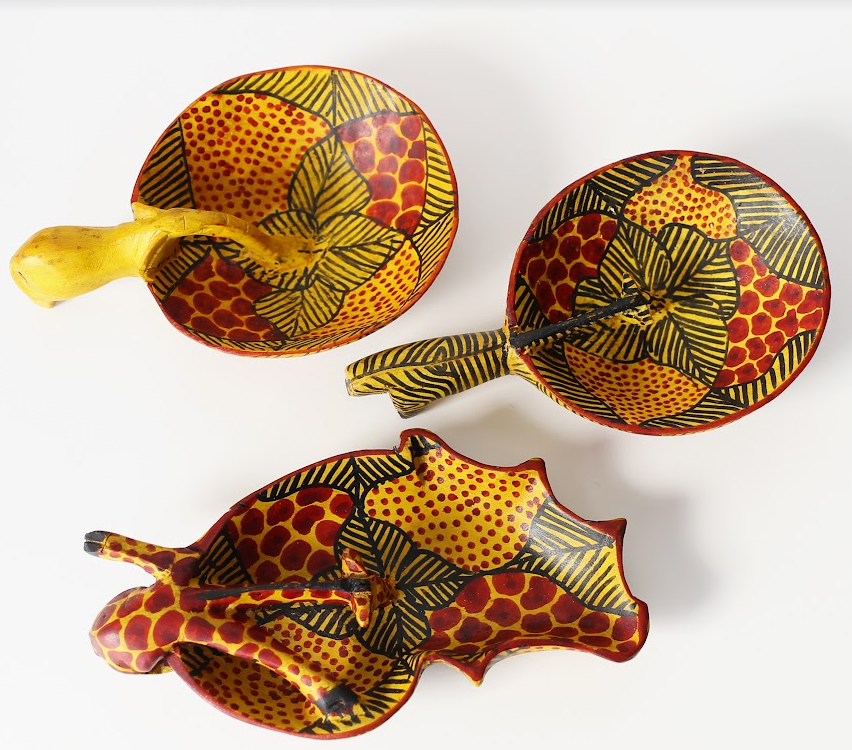 Hand-carved wooden safari animal bowl featuring a painted giraffe, elephant, and zebra.