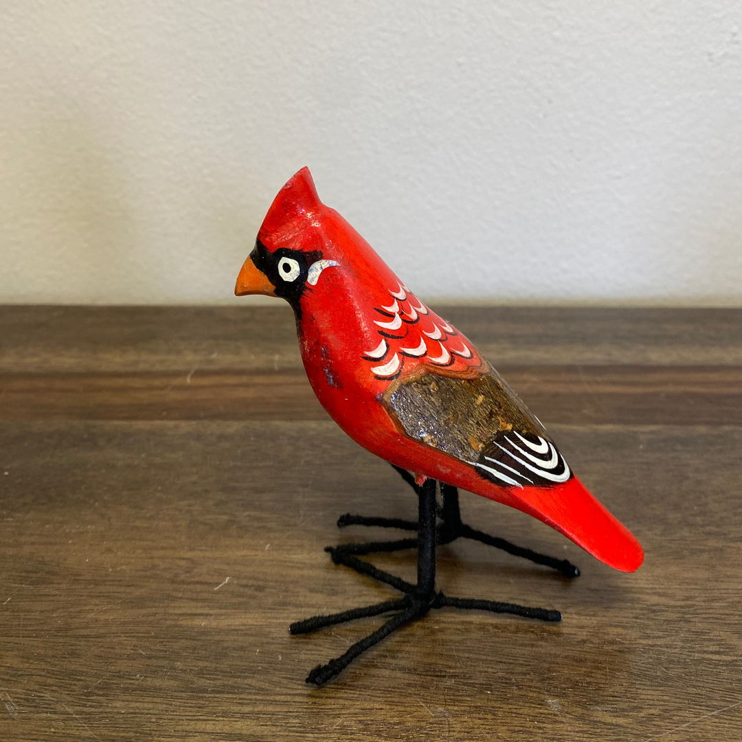 Front view of hand carved wooden cardinal ornament, painted red with black facial details, artisan-made in Kenya, fair trade.