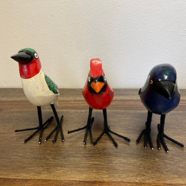 Set of three hand carved and painted wooden bird ornaments, bluebird, cardinal, and hummingbird, standing upright, fair trade from Kenya.