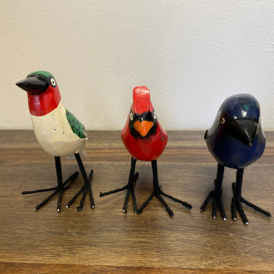 Set of three hand carved and painted wooden bird ornaments, bluebird, cardinal, and hummingbird, standing upright, fair trade from Kenya.