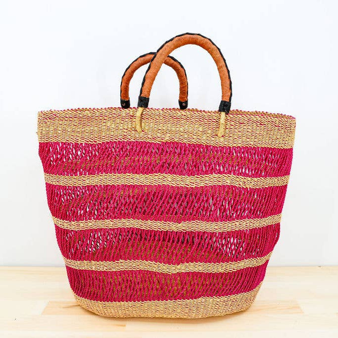 Fairtrade, hot pink, vetiver grocery tote with hand-dyed detail and leather handles.