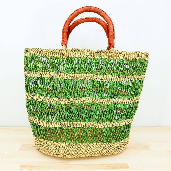 Green eco-friendly vetiver grocery tote with hand-dyed detail and leather handles.

