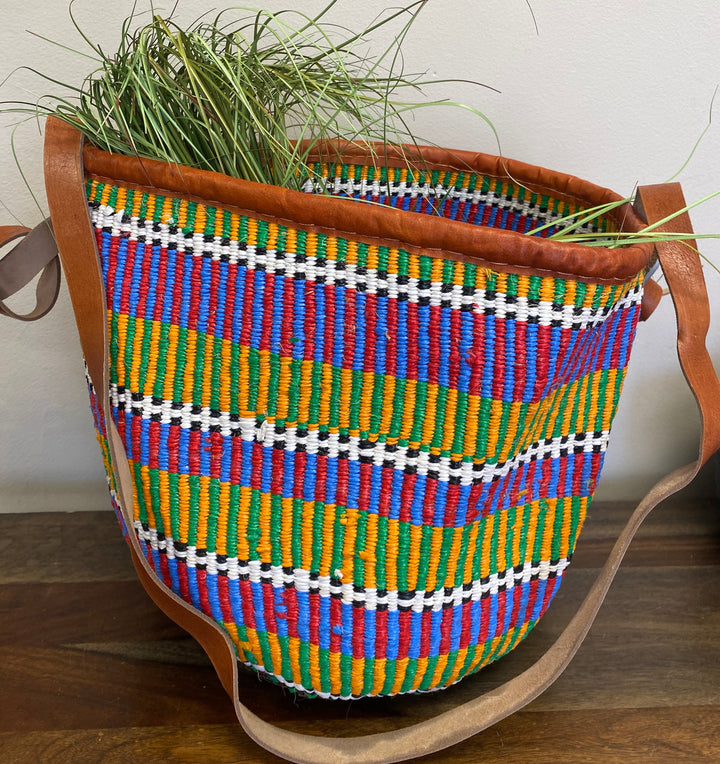 Open-top woven tote bag with leather trim and long leather handles, artisan-crafted in Kenya.
