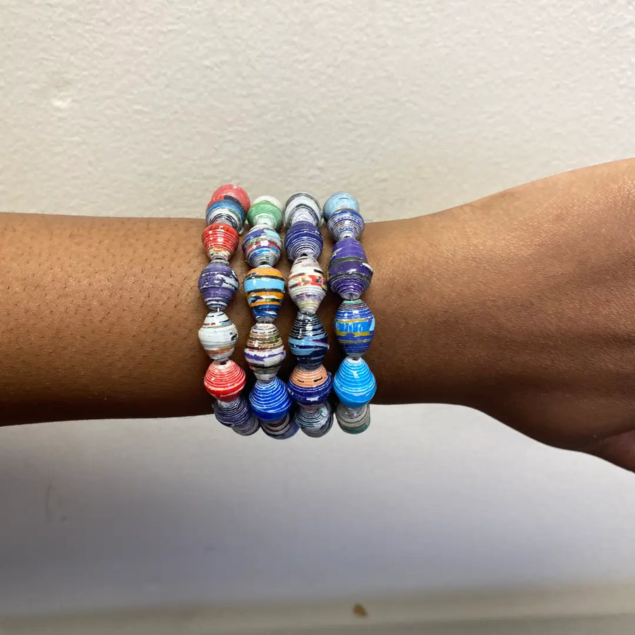 Close-up of colorful handmade paper mache bracelet made from magazine paper.