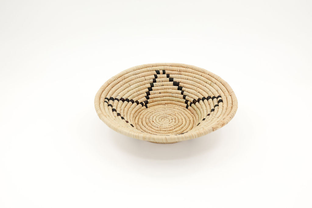 Natural-colored fair trade raffia bowl basket, handmade African decor perfect for wall hanging, eco-friendly home styling.