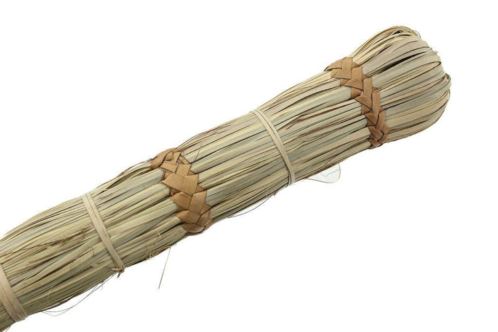 Natural tabletop crumb broom, handwoven from palm leaves for functional and decorative use.