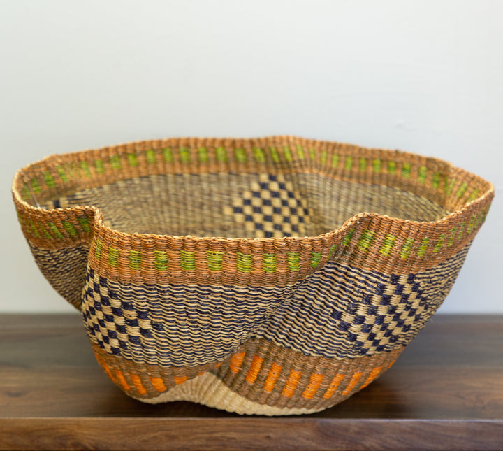 Artisan-made Bolga basket with sturdy leather handle.