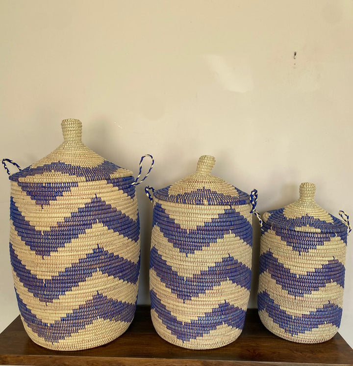 Handwoven nesting trio hampers in matching blue and beige colors to brighten the house and used for storage.