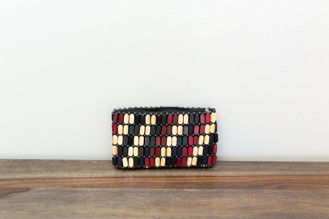Neutral colored clutch bag made out of wood sourced from Kenya