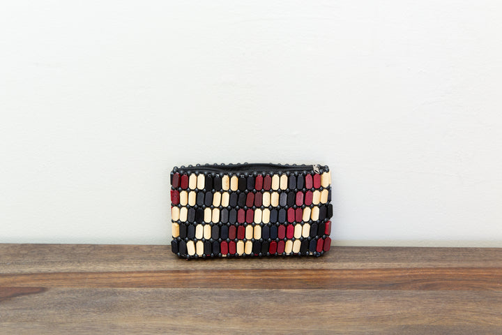 Neutral colored clutch bag made out of wood sourced from Kenya