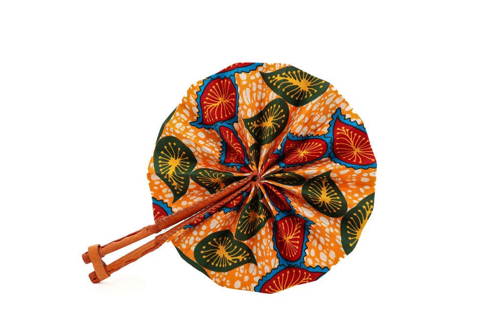 Portable fair trade fan with bold multicolor design.