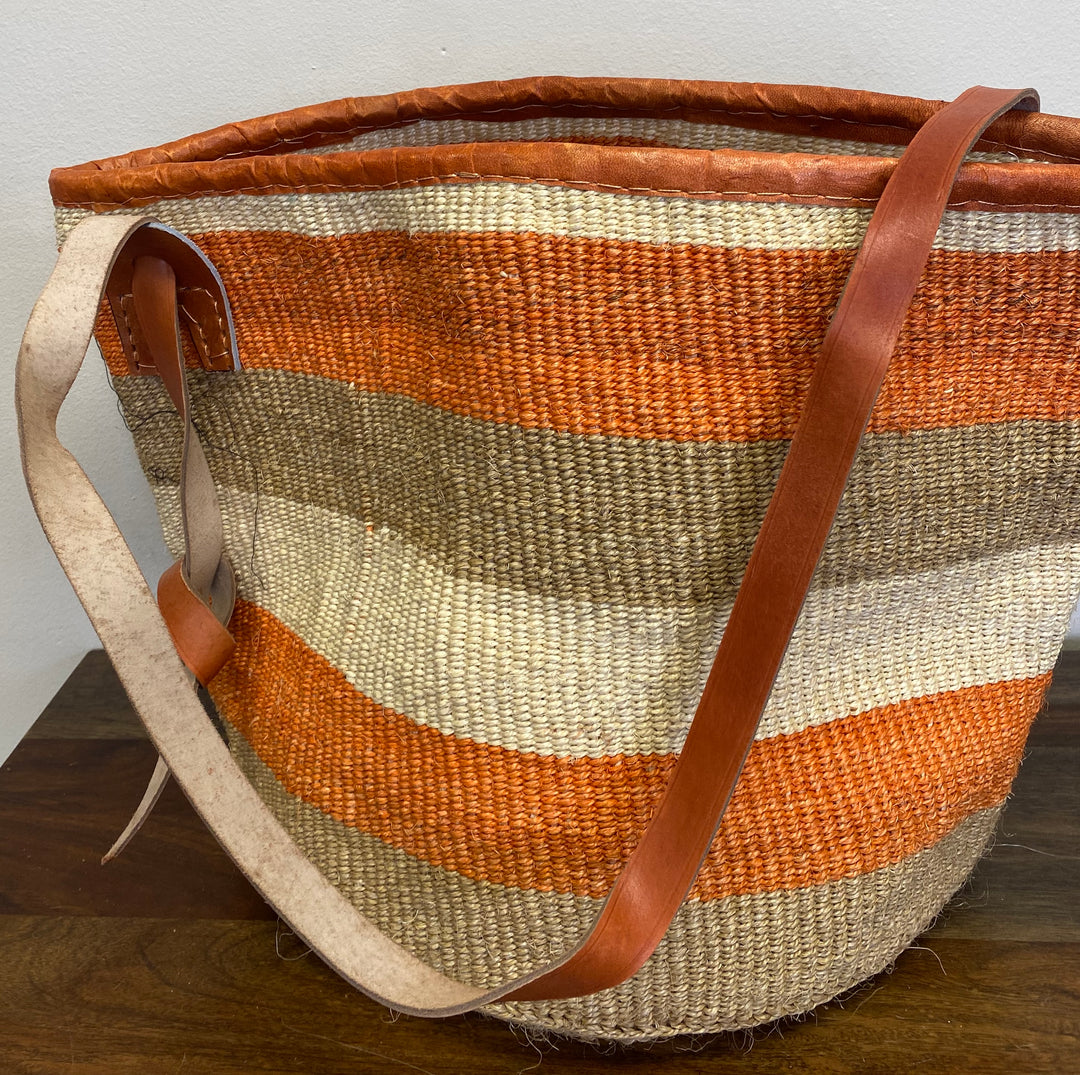 Sustainable sisal tote with open top and long leather strap, fair trade.