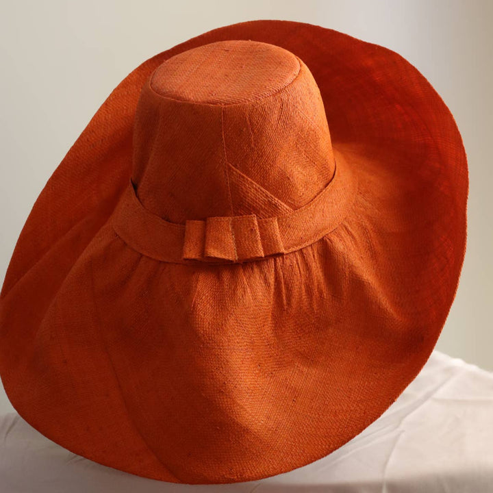 Artisan-made wide-brim hat in assorted natural styles.