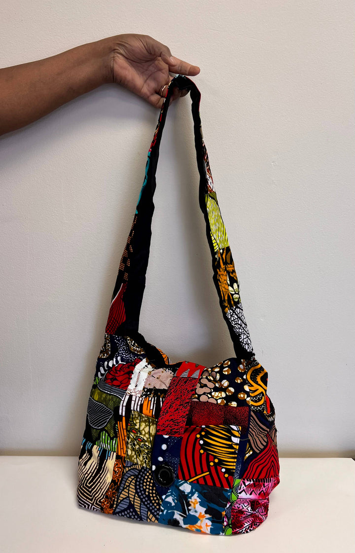 Colorful patchwork crossbody bag made from up-cycled fabric, handmade by fair trade artisans.