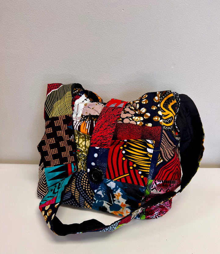 Eco-friendly shoulder bag featuring vibrant remnant textiles and sustainable design.
