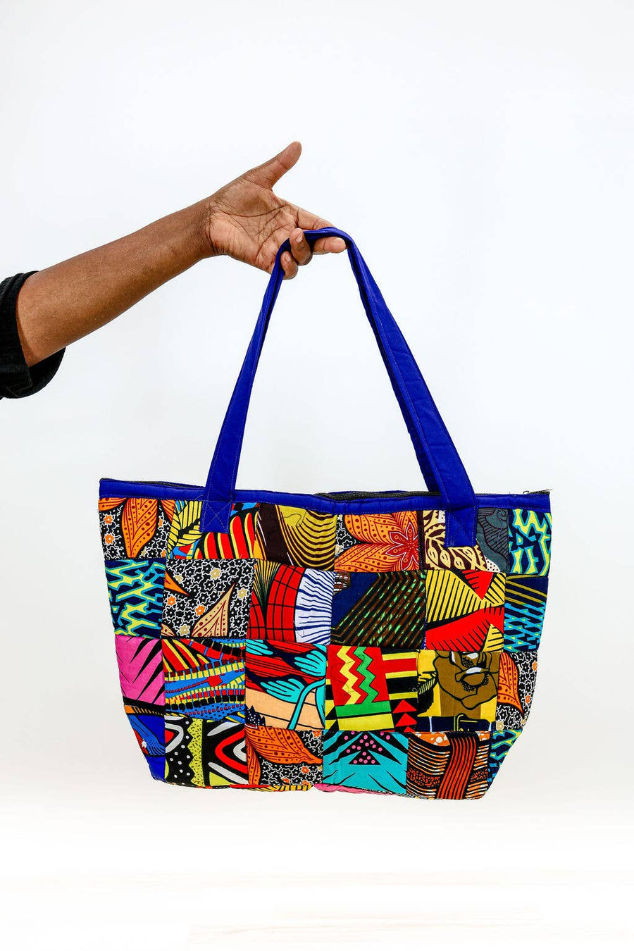 Up-cycled patchwork tote bag made from remnant fabric with zipper closure.
