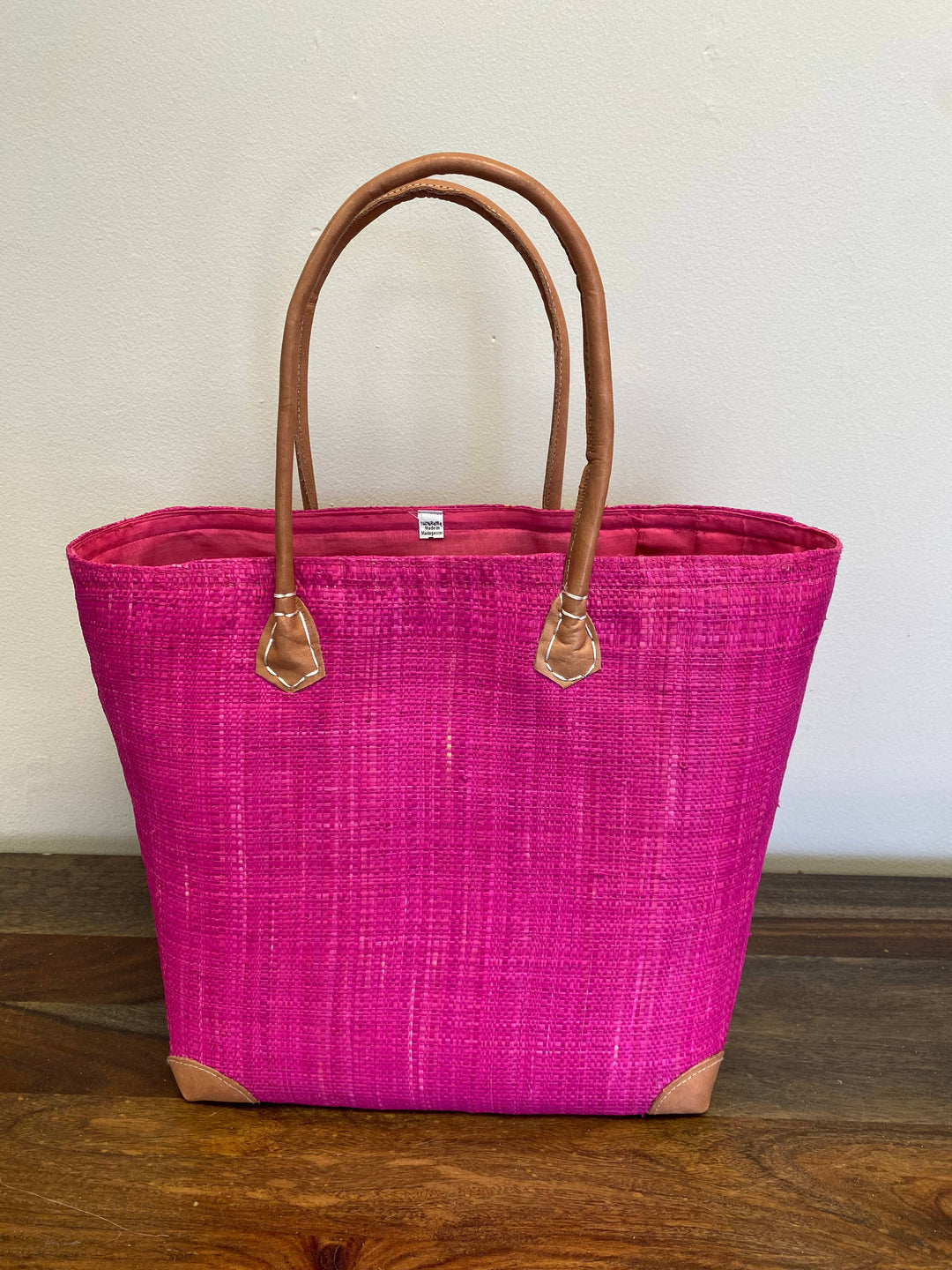 Versatile solid color woven bag for market shopping or beach trips.