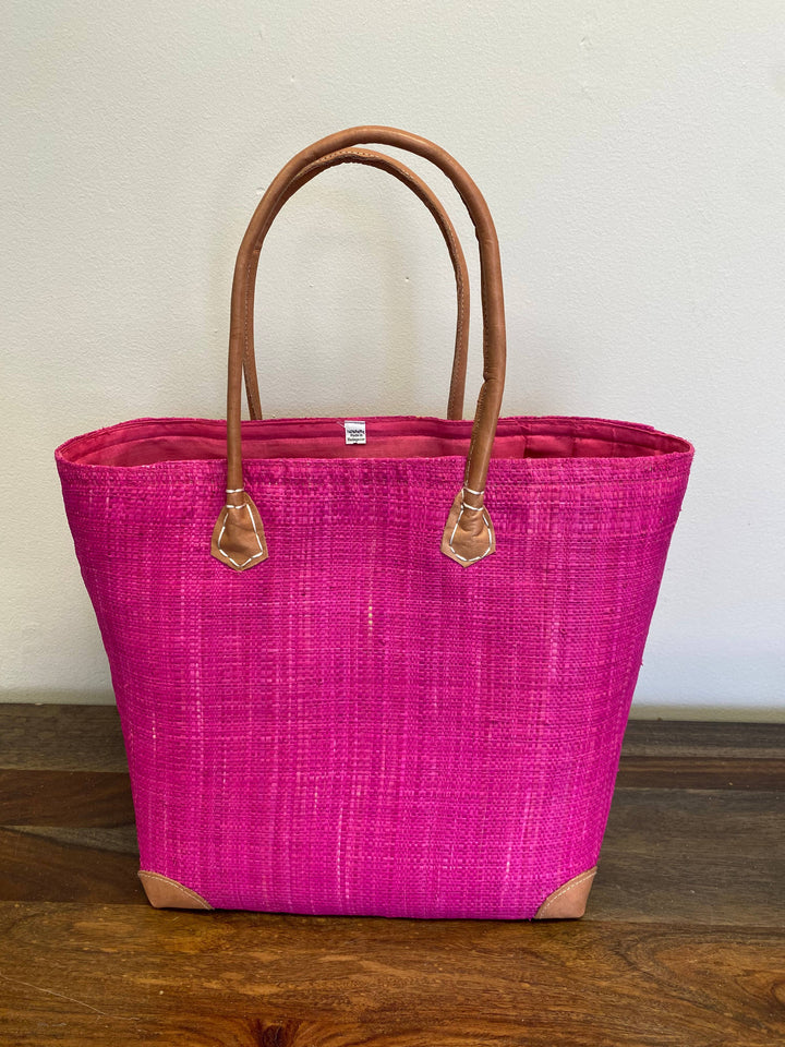 Versatile solid color woven bag for market shopping or beach trips.