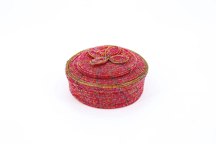 Close-up of beaded flower lid on round jewelry container.