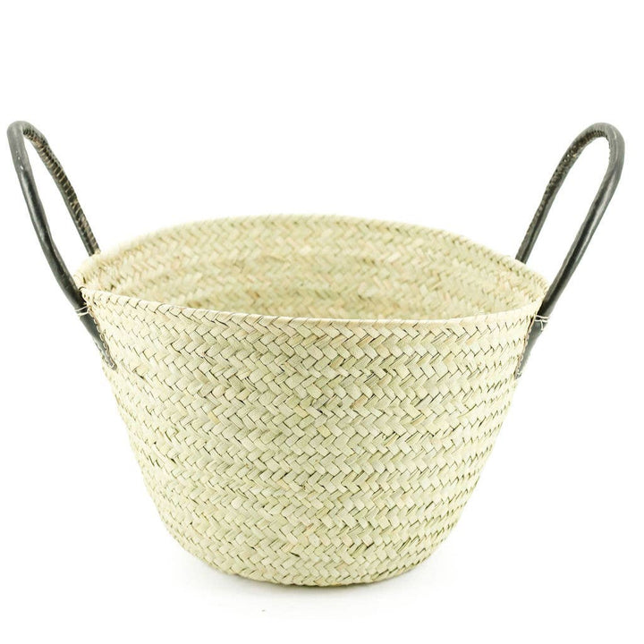 Artisan-made woven palm basket displayed as home décor with multi-functional use.