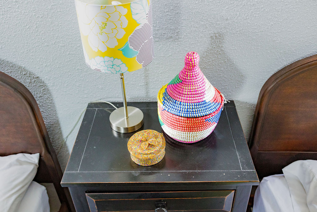Bold rainbow block lidded basket made from sweet grass and recycled plastic.