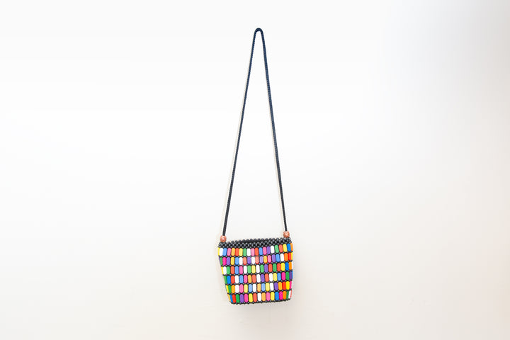 Fair-trade, rainbow colored crossbody purse with wood details that is handmade by artisans in Africa. 