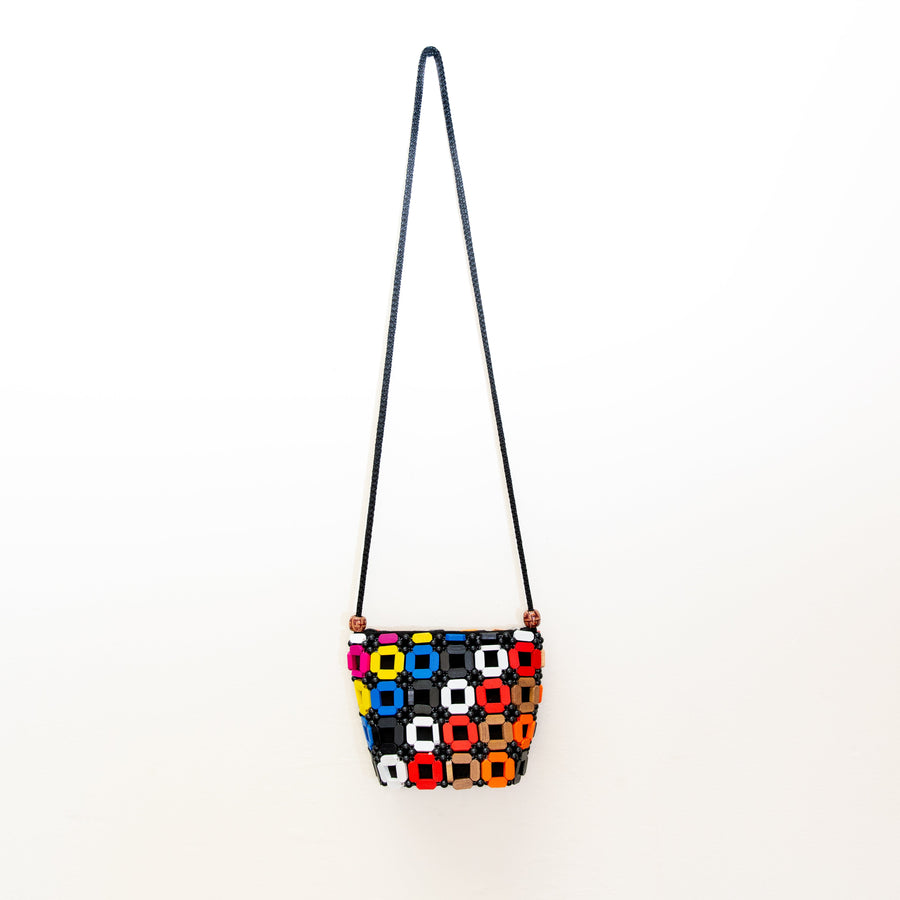 Rainbow multicolor square wooden crossbody purse with center cutouts, handmade in Kenya from fair trade African wood beads in a bold geometric design.