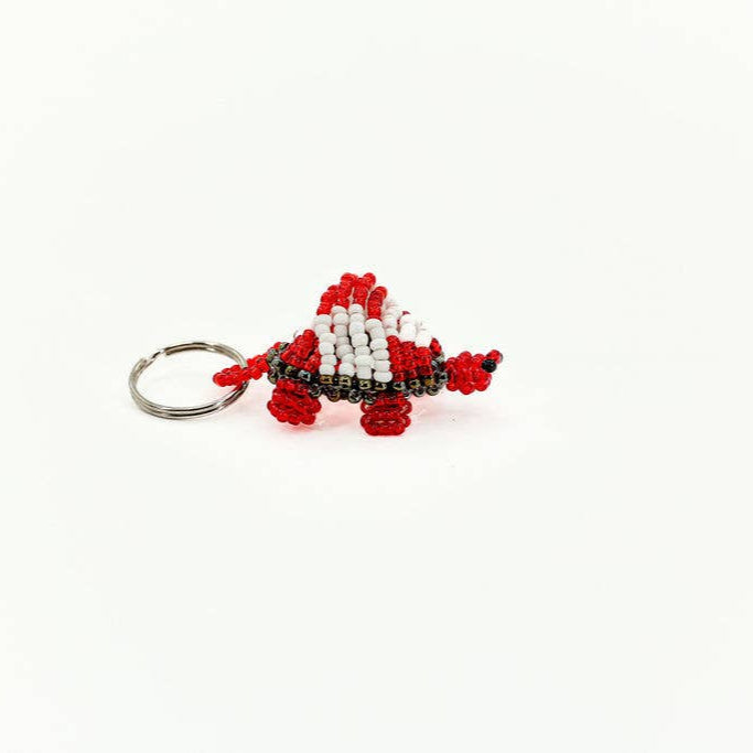Hand-beaded giraffe keychain in red and white glass beads, fair trade and handmade.