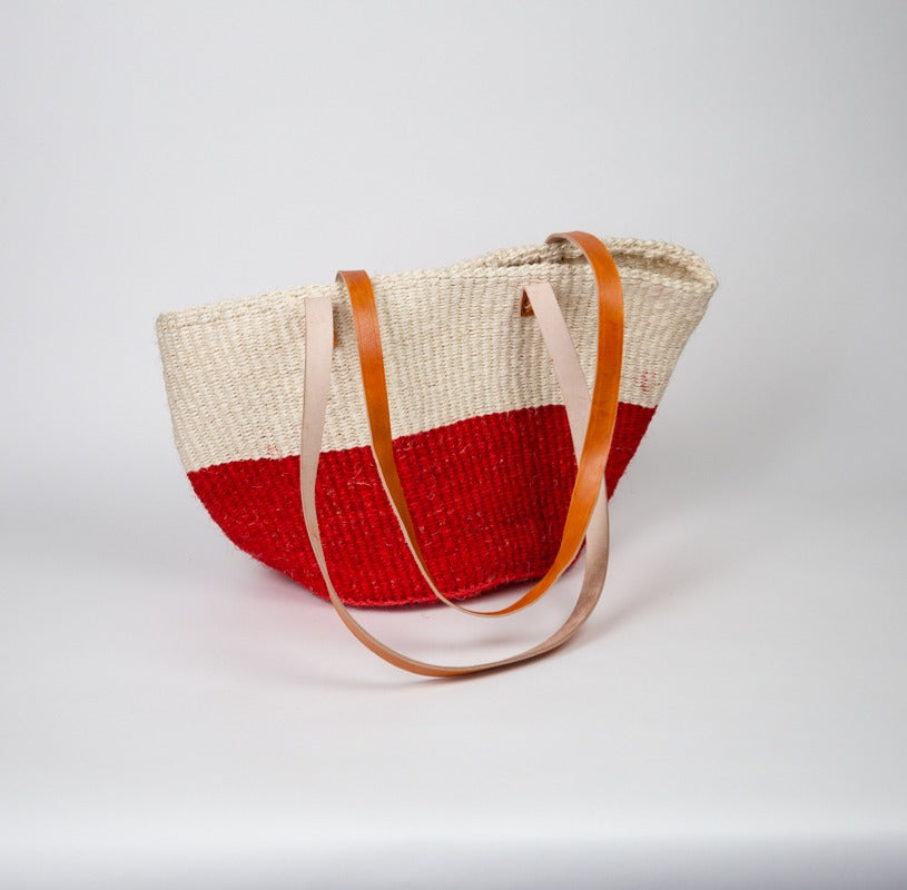 Red and white striped sisal tote bag with leather straps, handcrafted in Kenya and perfect for daily use or stylish storage.