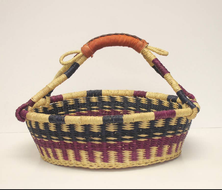 Multi-use round basket made from handwoven vetiver grass, ideal for storage, décor, or serving.