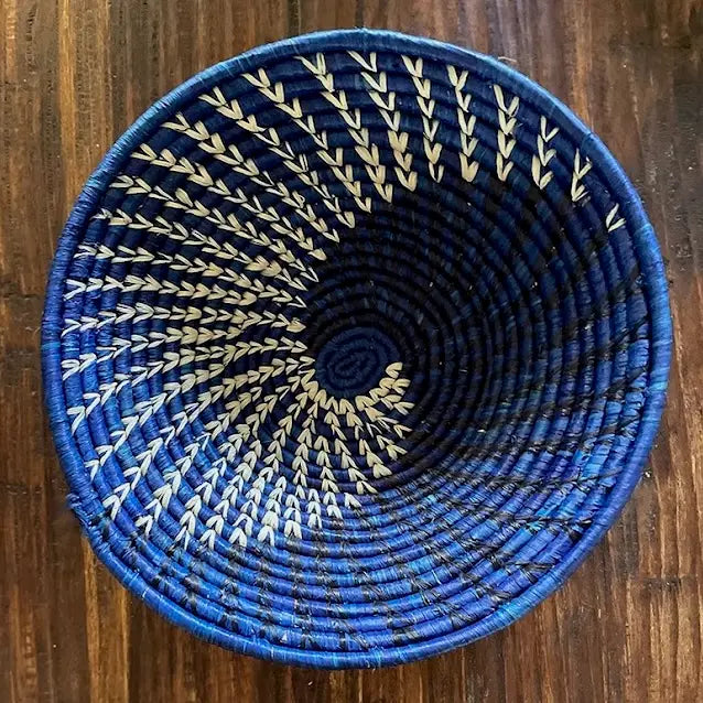 Fair trade royal blue raffia bowl basket, handmade using sustainable natural fibers. This basket is an eco-friendly African decor perfect for functional storage and home styling.