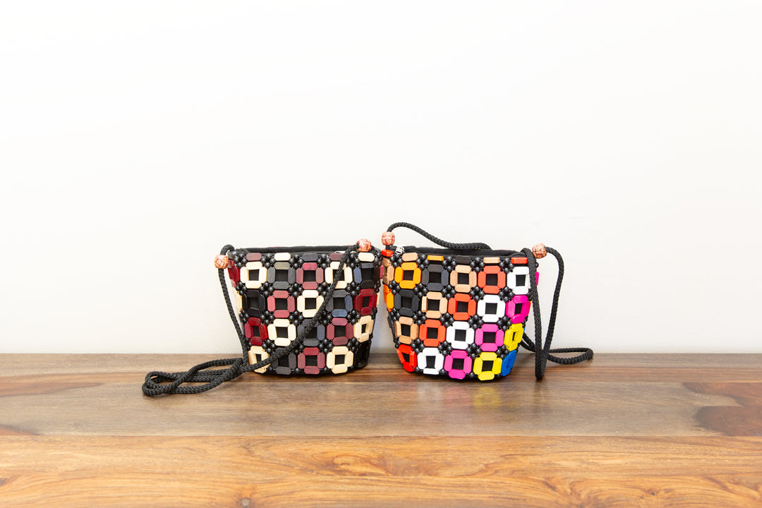 Two colorful crossbody handbags that are handmade by fair-trade artisans in Africa.