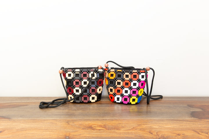 Two colorful crossbody handbags that are handmade by fair-trade artisans in Africa.