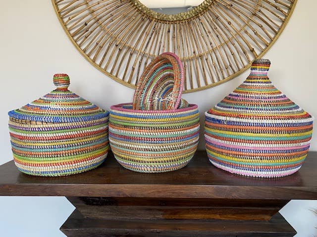 Fair trade rainbow artisan basket in assorted colors, perfect for tabletop or shelf decor.