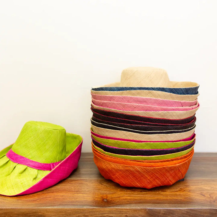 Colorful woven baskets on a wooden surface with a plain background