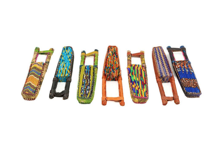 Assorted African fabric fans displayed in rainbow colors.