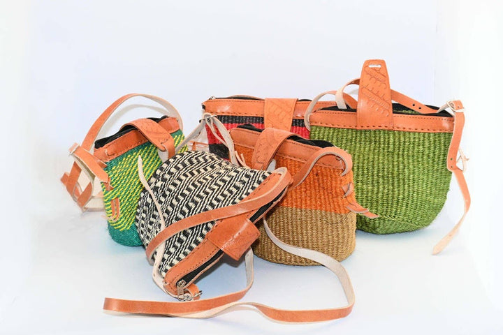 Artisan-woven sisal purse with adjustable leather crossbody strap.
