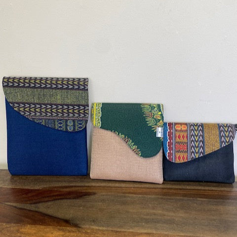 Collection of patterned fabric samples on a wooden surface in small, medium, and large.