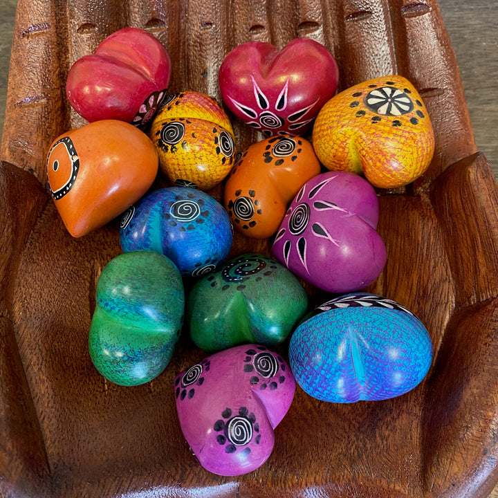 Colorful handcrafted soapstone hearts for gifts or decor.