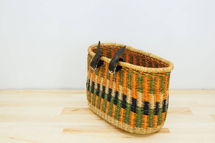 Sustainable fair trade bicycle basket, hand-dyed elephant grass with leather handles and brass buckles.