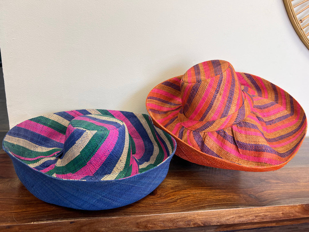Handwoven raffia sun hat with wide brim and adjustable drawstring.