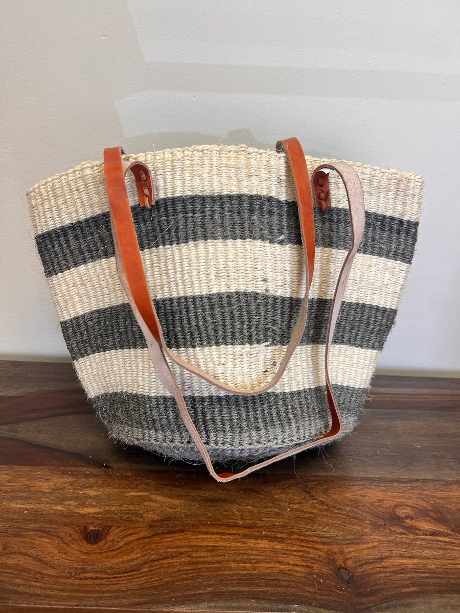 Striped fair trade woven tote bag with leather straps, handmade from sisal fiber in Kenya.